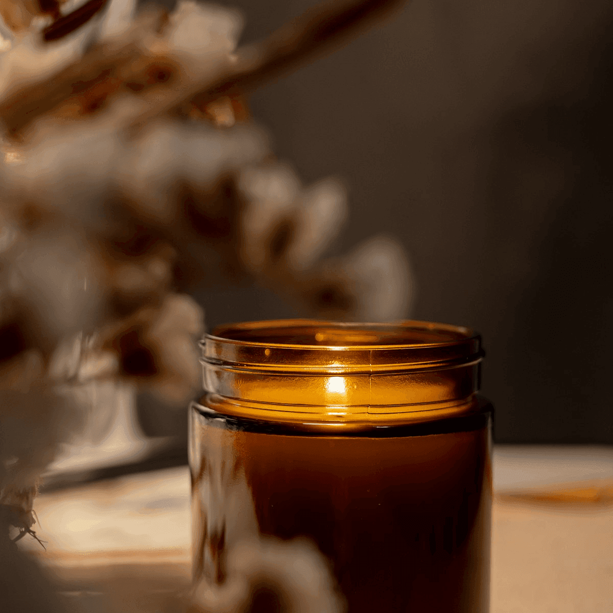Amber glass candle on linen