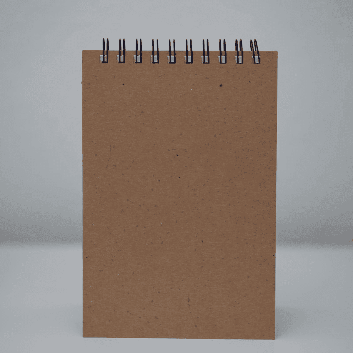 Three stacked kraft notebooks