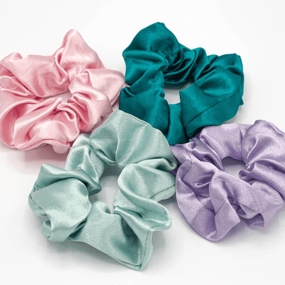 Three silk scrunchies in blush and ivory