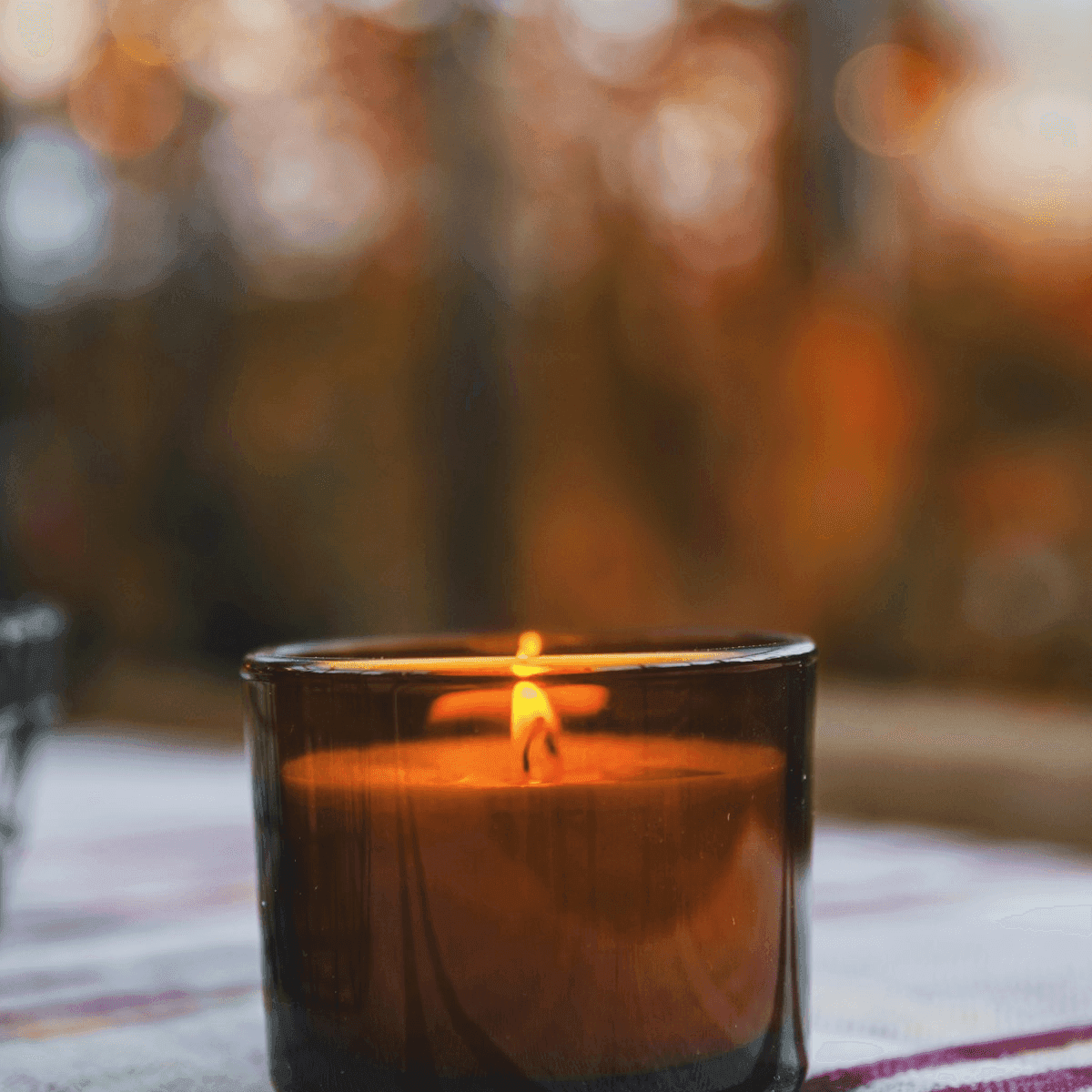 Small amber tin candle